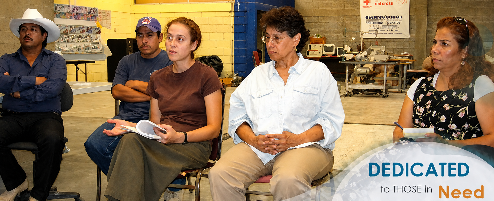 Adults seated at tables during a community meeting